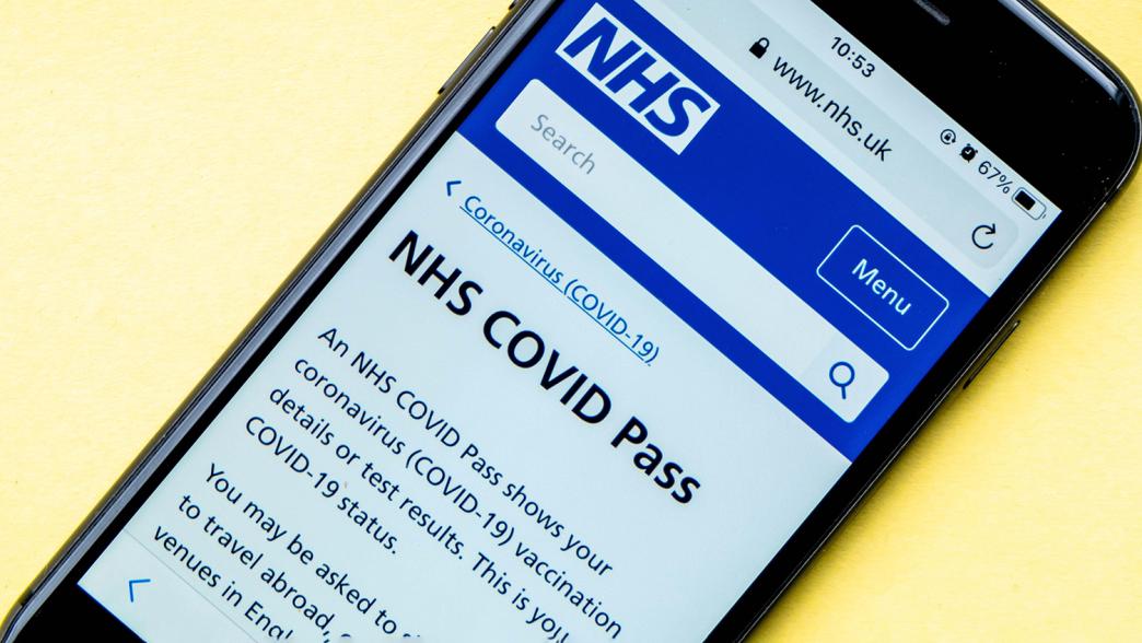 An image of a phone with the NHS Covid Pass webpage displayed.