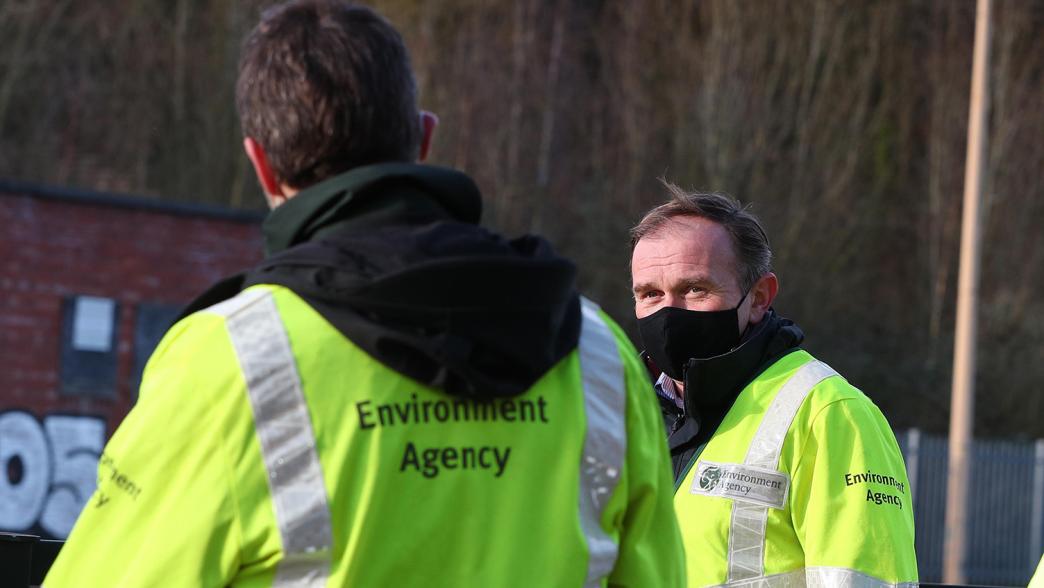 Former environment secretary George Eustice talks to Environment Agency staff in Cheshire following Storm Christoph.