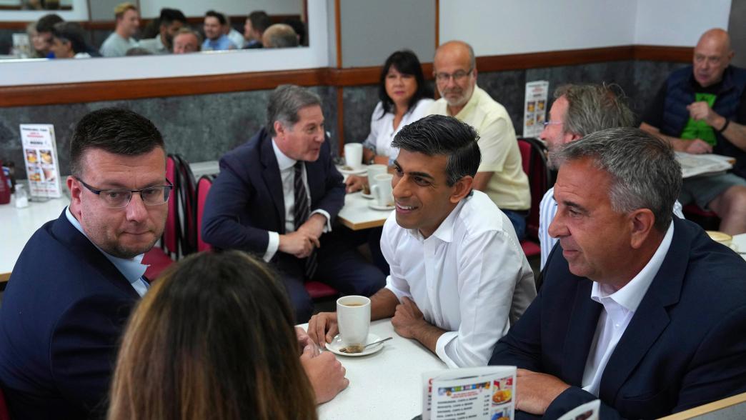 Prime minister Rishi Sunak and newly elected Conservative MP Steve Tuckwell, right, speak to party activists at the Rumbling Tum cafe in Uxbridge.