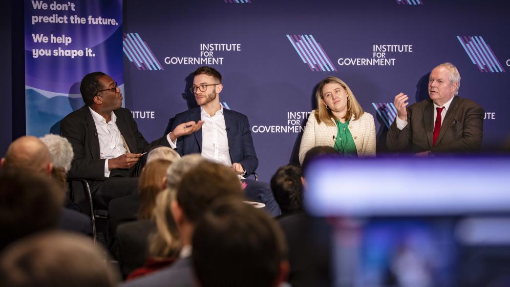 A panel on stage at the Institute for Government, with Kwasi Kwarteng, Nick Davies, Georgia Gould, and Adam Boulton.