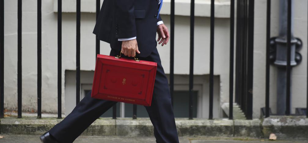Philip Hammond walking down Downing Street with the budget briefcase in hand. 