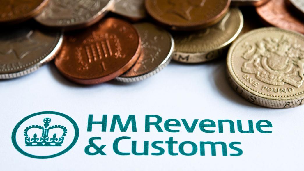 Close up of coins and a HMRC tax form