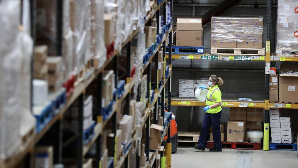 A worker gather supplies at the NHS' National Procurement Warehouse at Canderside, Larkhall