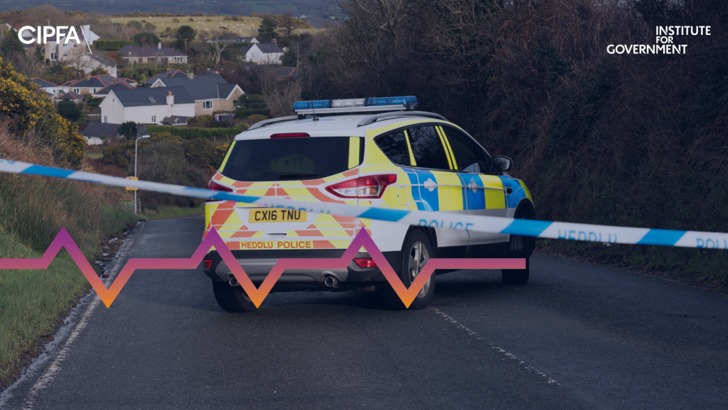 A police vehicle on a road in North Wales. There is a cordoned off police rope in front.
