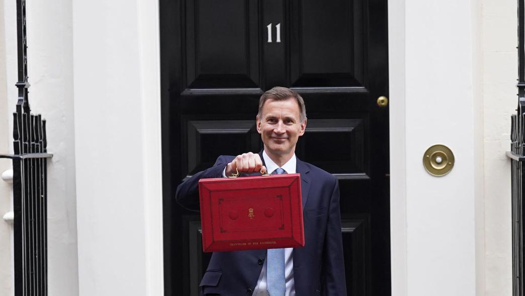 Jeremy Hunt, chancellor, outside No 11 Downing Street with the budget case in his hand.