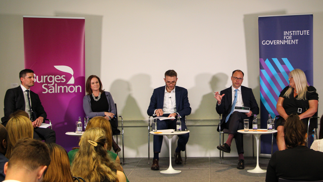 Panellists on stage at an event on NHS procurement.