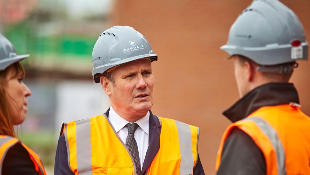 Leader of the opposition Keir Starmer in a high vis jacket and hardhat