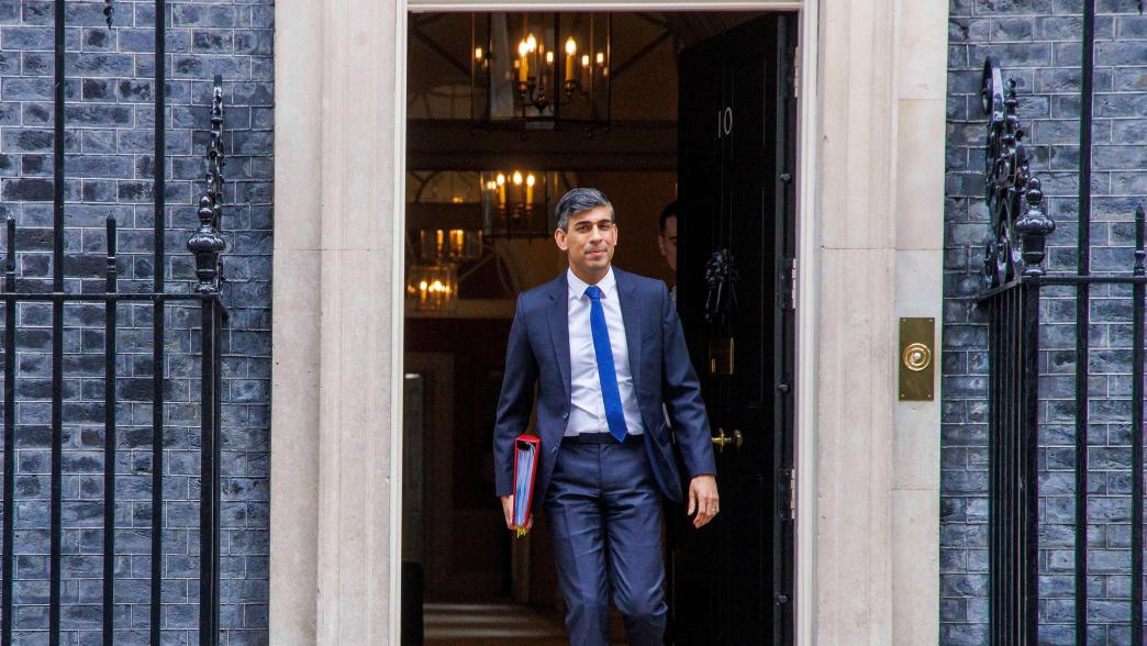 Rishi Sunak walking out the door of No.10 Downing Street.