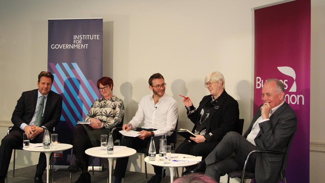 An IfG panel on stage discussing the Procurement Act. From left to right: Andy Milner, Chief Executive Officer of Amey; Laura Wisdom, Partner at Burges Salmon; Nick Davies from the IfG; Lindsay Maguire, Deputy Director for Procurement Reform Implementation at the Cabinet Office; and Peter Schofield, Head of Integrated Commissioning and Procurement at Manchester City Council; 