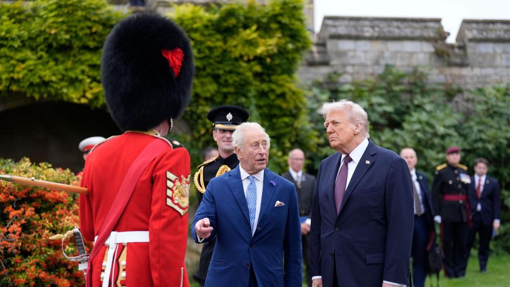 King Charles III (centre) and US President Donald Trump (right) meet military personal after a Beating Retreat military ceremony at Windsor Castle