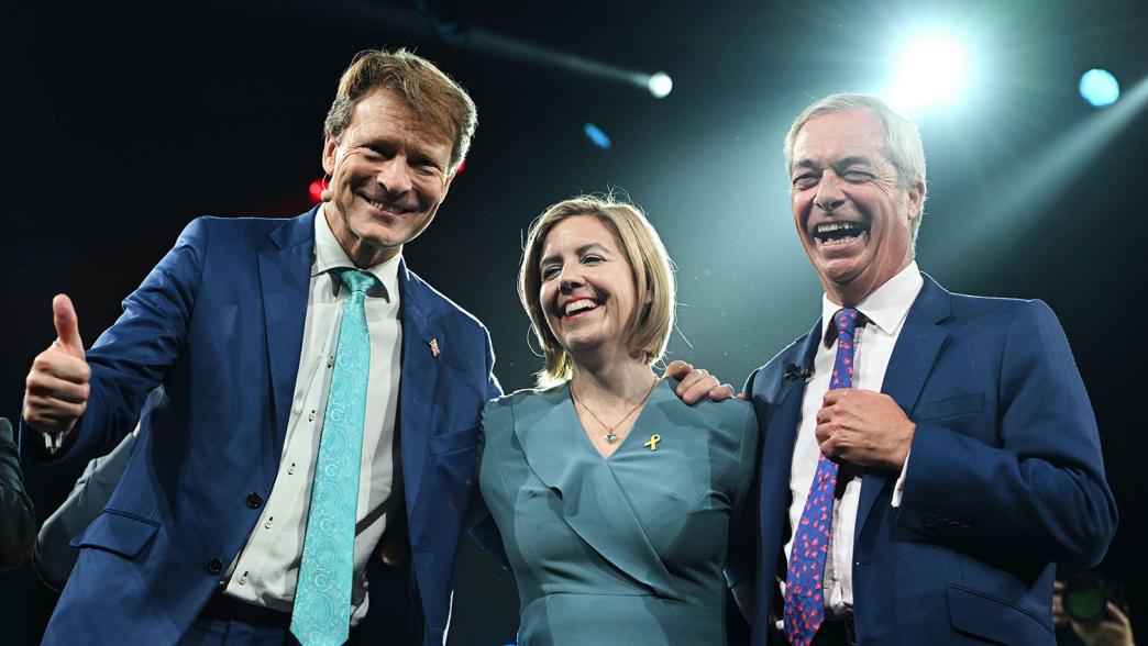 Britain's Reform UK party leader Nigel Farage right, Andrea Jenkyns and Richard Tice pose for photographers during the Reform party's annual conference at the National Exhibition Centre in Birmingham.