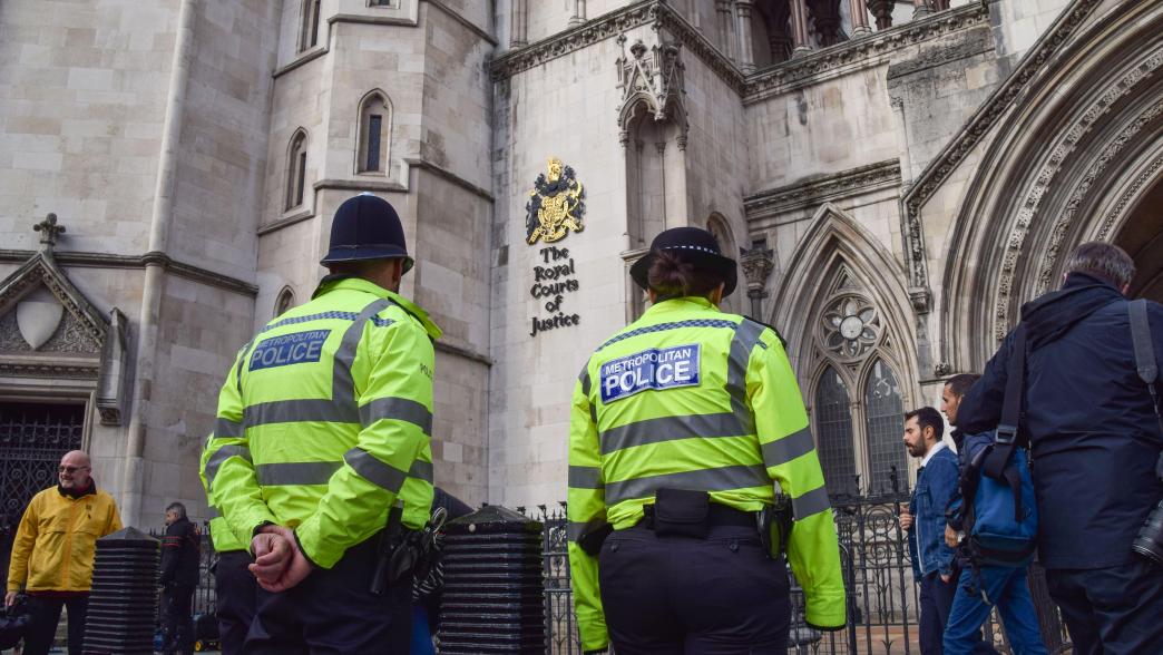 Police officers outside The Royal Courts of Justice.