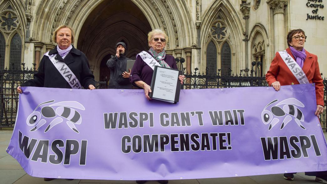 Women Against State Pension Inequality (WASPI) campaigners stand outside the Royal Courtf of Justice as they take the government to court over compensation for women who were affected by changes to the state pension age.