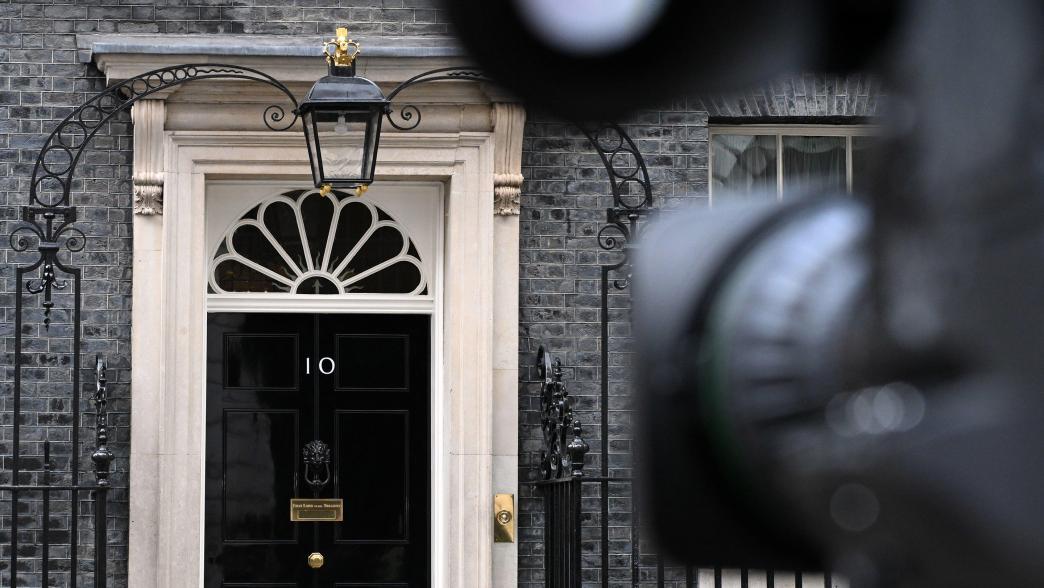A TV camera points at the door of 10 Downing Street.