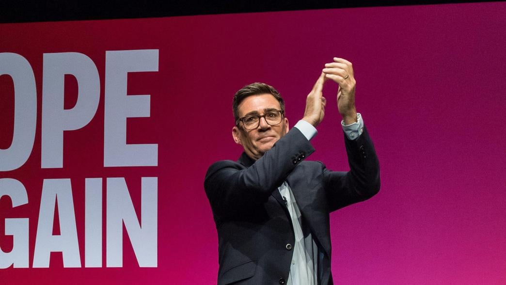 Andy Burnham on stage at the Labour Party Conference. Behind him the screen reads: Hope Again