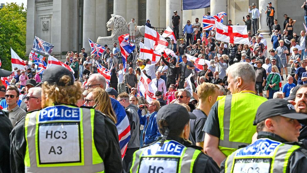 Police with people outside the Portsmouth Guildhall during a South Coast Patriots march.
