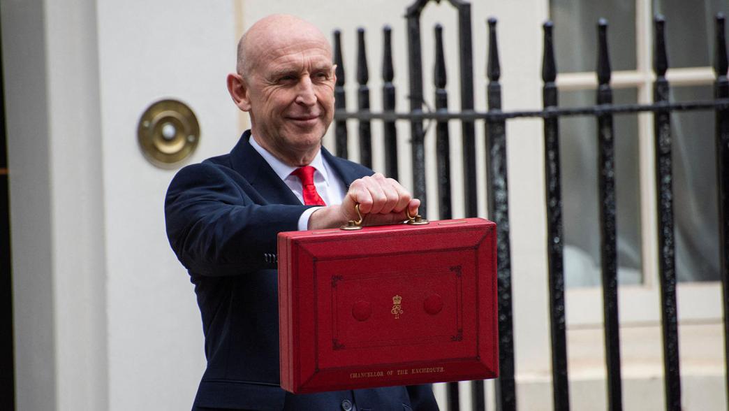 John Healey with the budget case outside No.11 Downing Street.