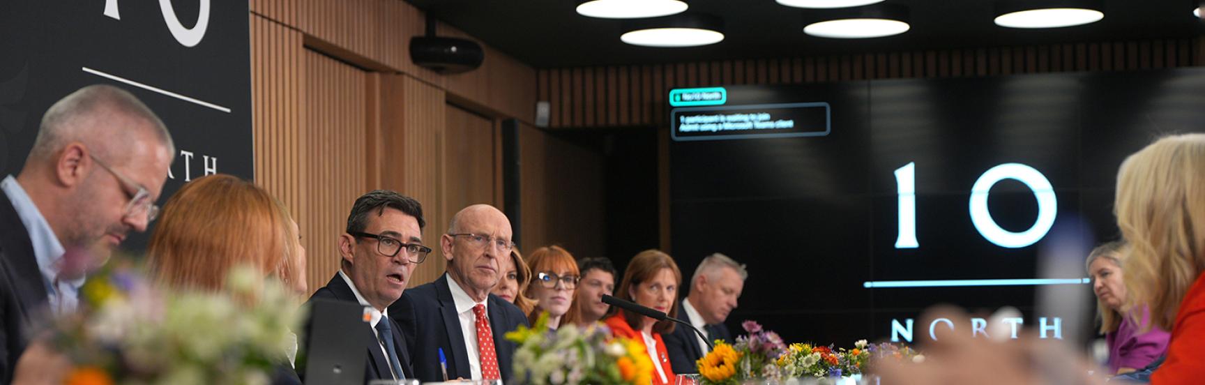 Prime Minister Andy Burnham (rear centre) sits between Cabinet Secretary Antonia Romeo (left) and Chancellor of the Exchequer John Healey (right) during a National Economic Council meeting at No 10 North