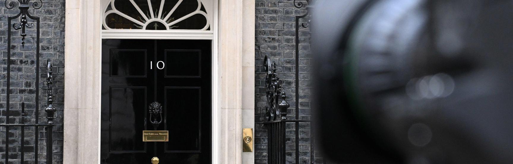 A TV camera points at the door of 10 Downing Street.