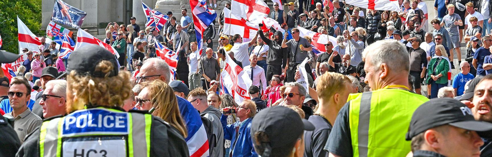 Police with people outside the Portsmouth Guildhall during a South Coast Patriots march.