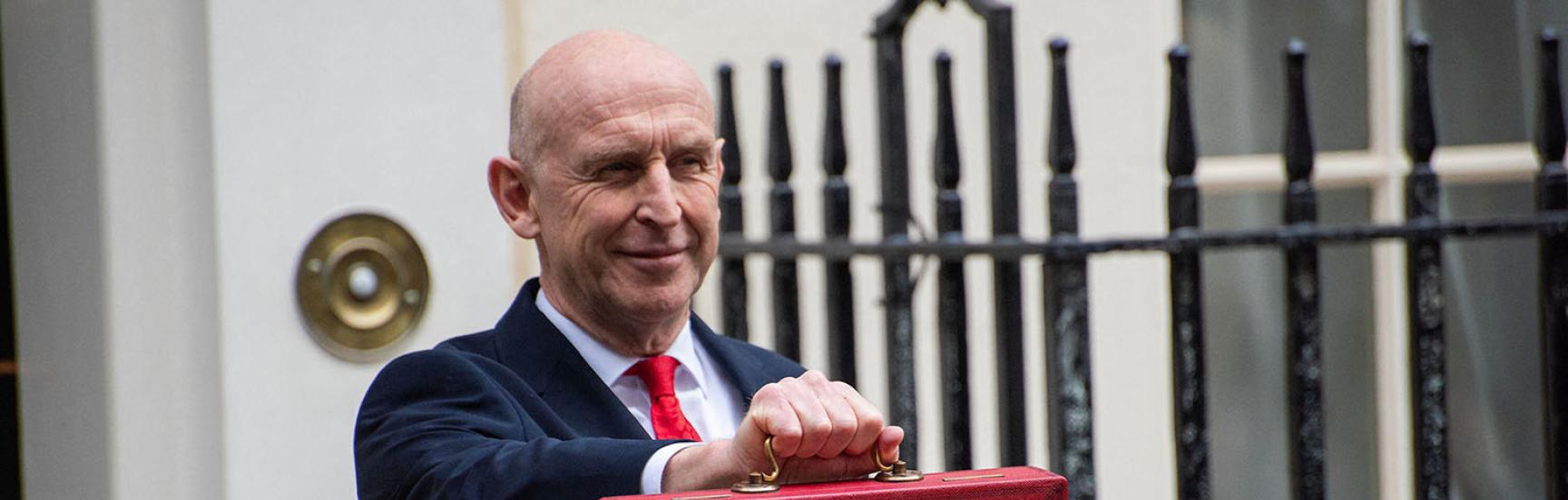 John Healey with the budget case outside No.11 Downing Street.
