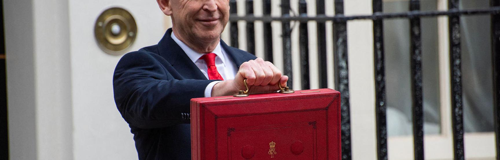 John Healey with the budget case outside No.11 Downing Street.