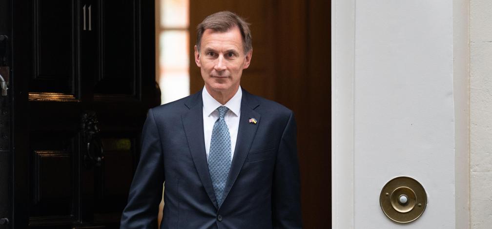 Chancellor Jeremy Hunt leaving Number 11 Downing Street. In his right hand he is carrying the autumn statement 2022.