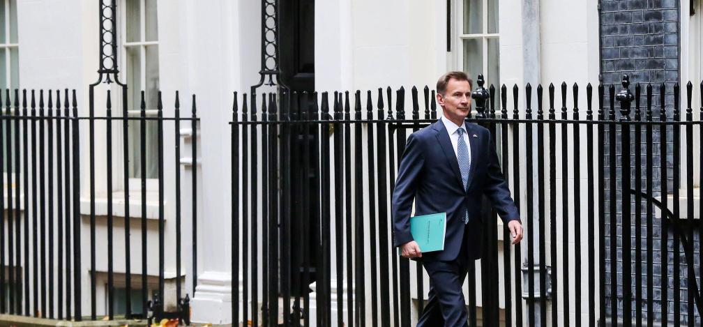 Jeremy Hunt, chancellor, outside No 11 Downing Street with the autumn statement in his hand.