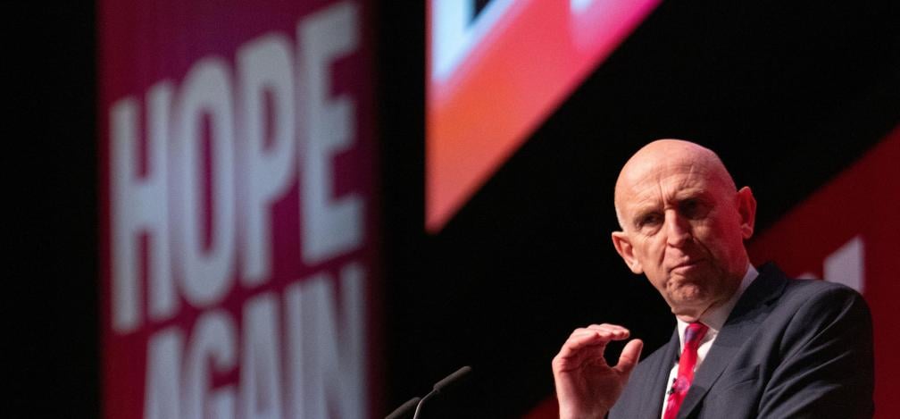 John Healey on stage at the Labour Party Conference.