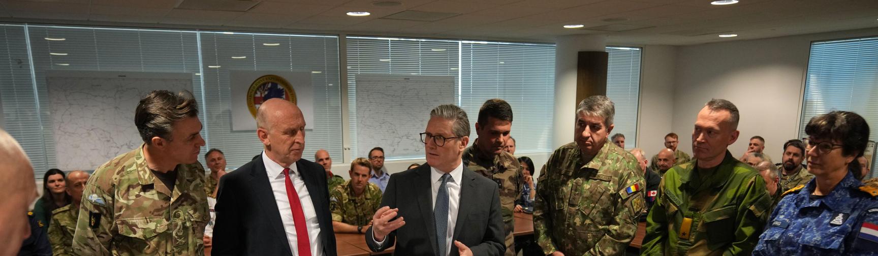 Prime Minister Sir Keir Starmer (center right) and Defence Secretary John Healey (centre left) speak to General Nick Perry Chief of Joint Operations (left) in front of a Ukraine map during a visit to a military base in south east England to meet with military planners mapping out next steps in the Coalition of the Willing.
