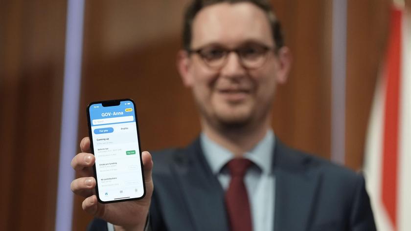 Darren Jones holding a demo version of the digital ID app.