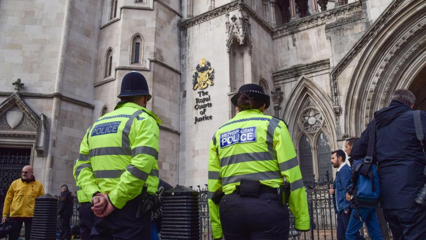 Police officers outside The Royal Courts of Justice.