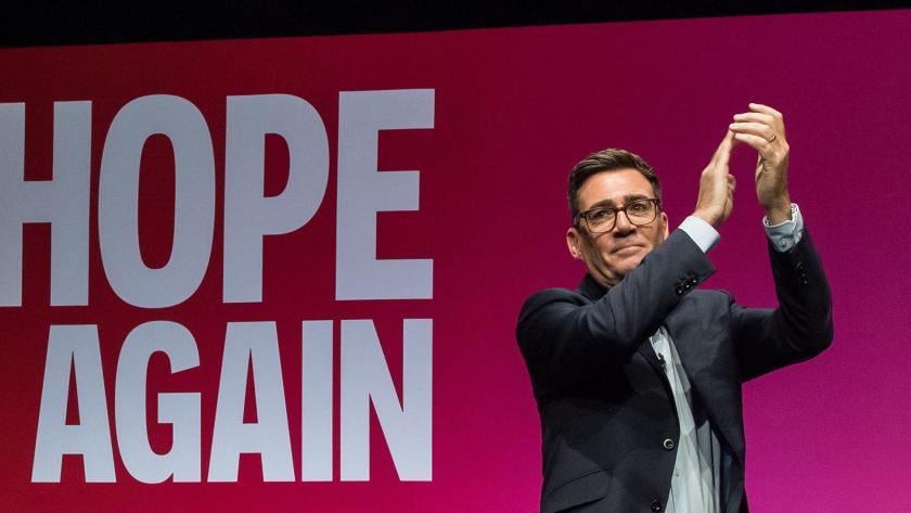 Andy Burnham on stage at the Labour Party Conference. Behind him the screen reads: Hope Again