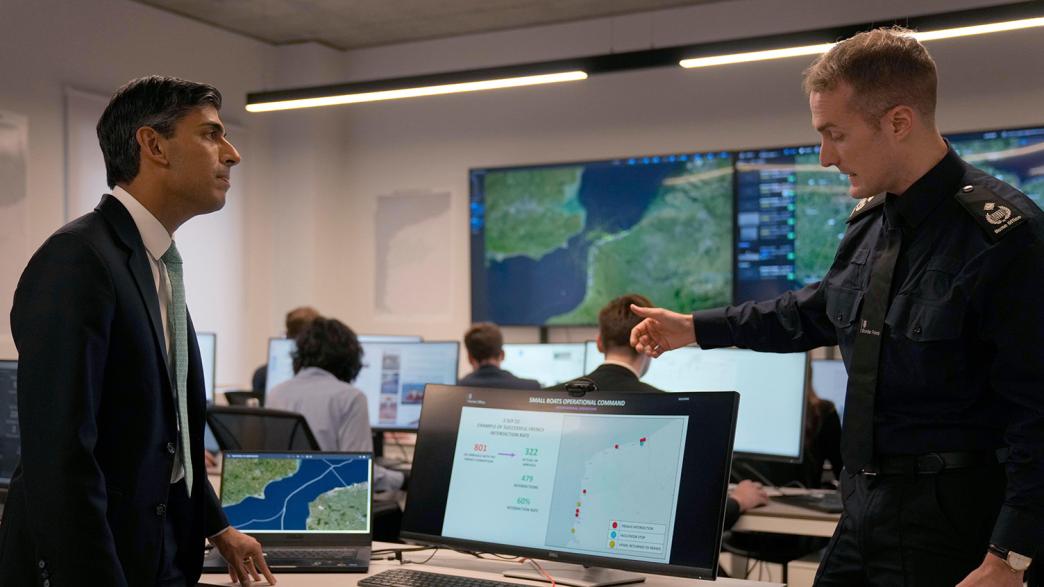 Rishi Sunak (left) speaks to a Border Force official during a visit to a central London security hub following the announcement of a new dedicated unit, the "small boats operational command", to tackle Channel crossings.
