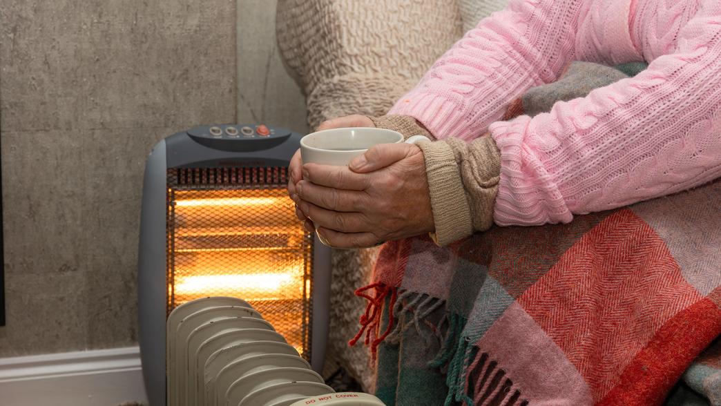 Pensioner female keeping warm during cold spell