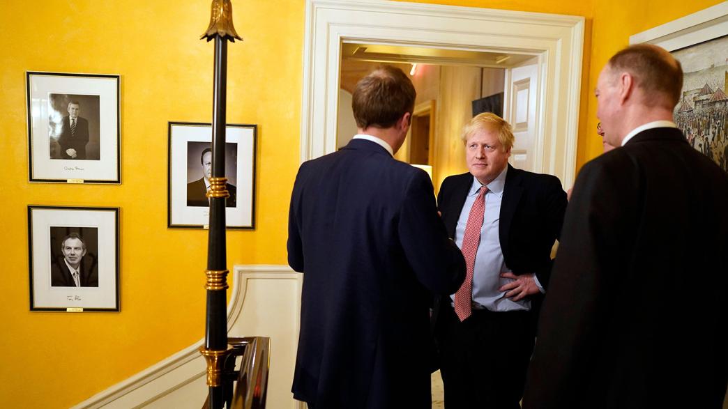 British Prime Minister Boris Johnson (C) talks to Britain's Secretary of State for Health and Social Care Matt Hancock (L) and Chief Medical Officer for England Chris Whitty after a press conference on the stairs of 10 Downing Street in London, Britain on March 12, 2020. 