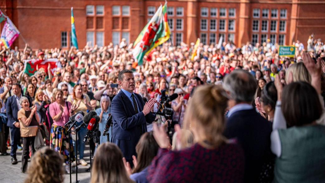 Plaid Cymru leader Rhun ap Iorwerth speaks to supporters, backed by his newly elected Senedd members on the steps of the Senedd, following winning the most seats in the Welsh Parliament election